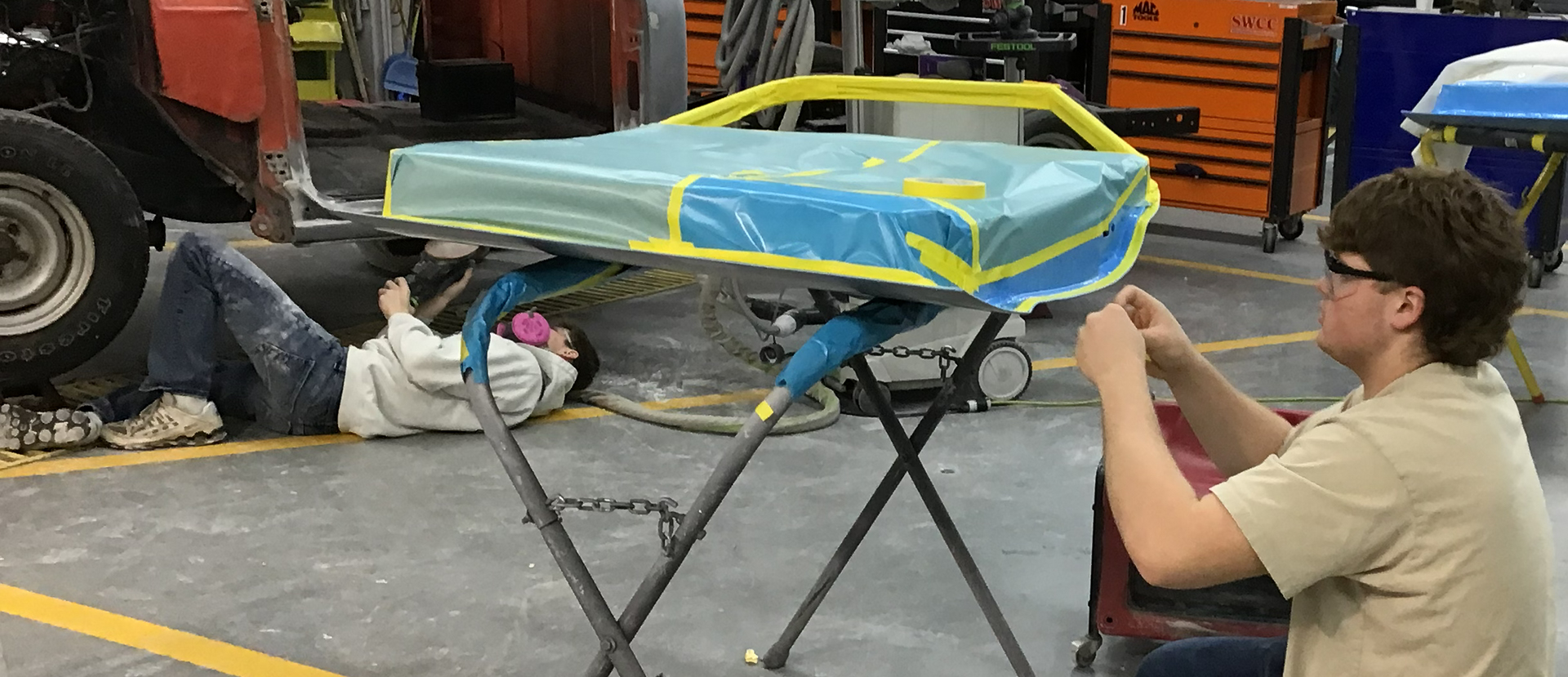 Two students working in the collision repair lab