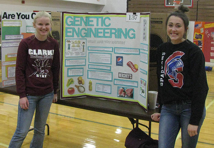 Two students with poster