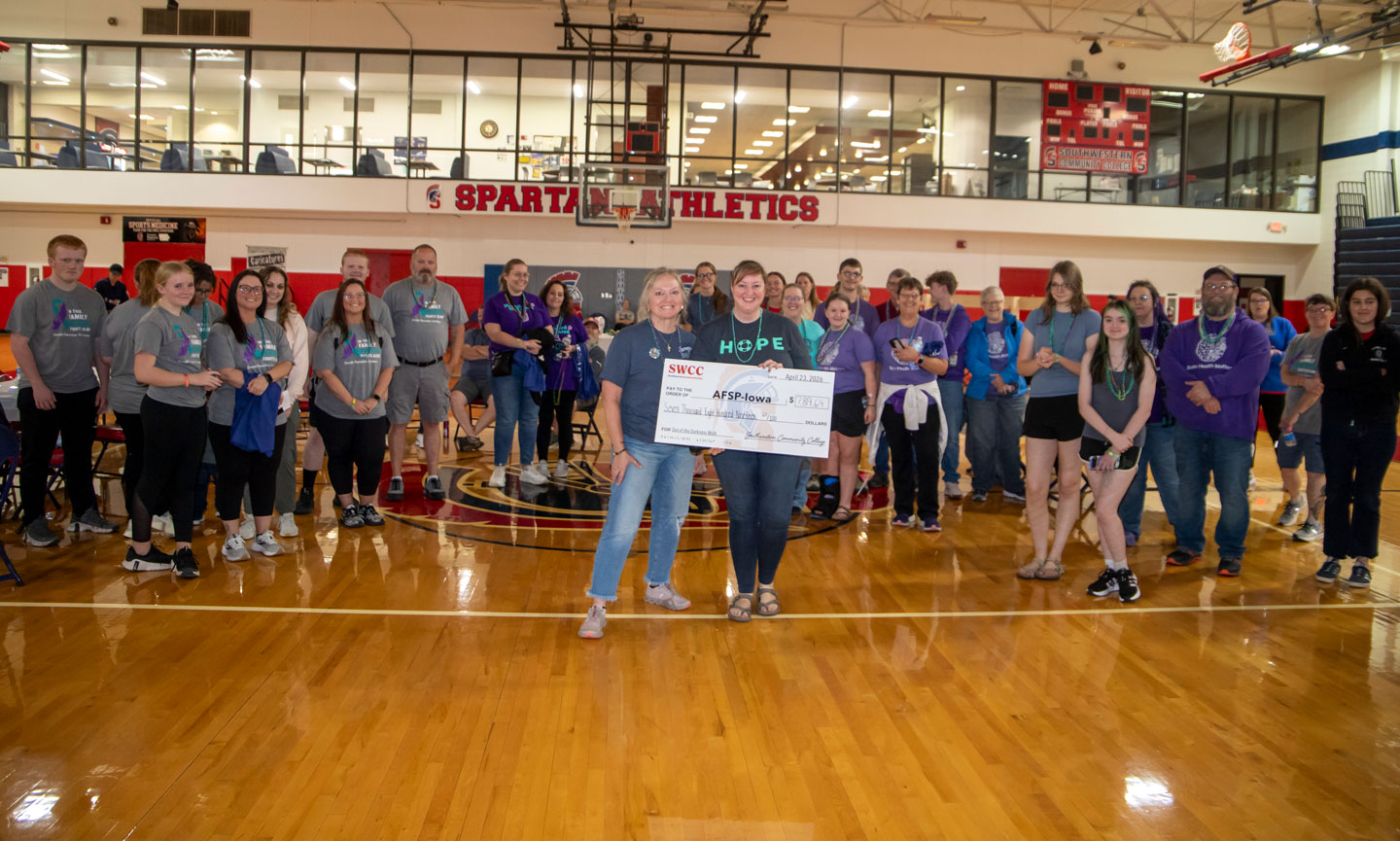SWCC's Terri Higgins presenting AFSP's Amara Huffline with a decorative check for $7,819.64