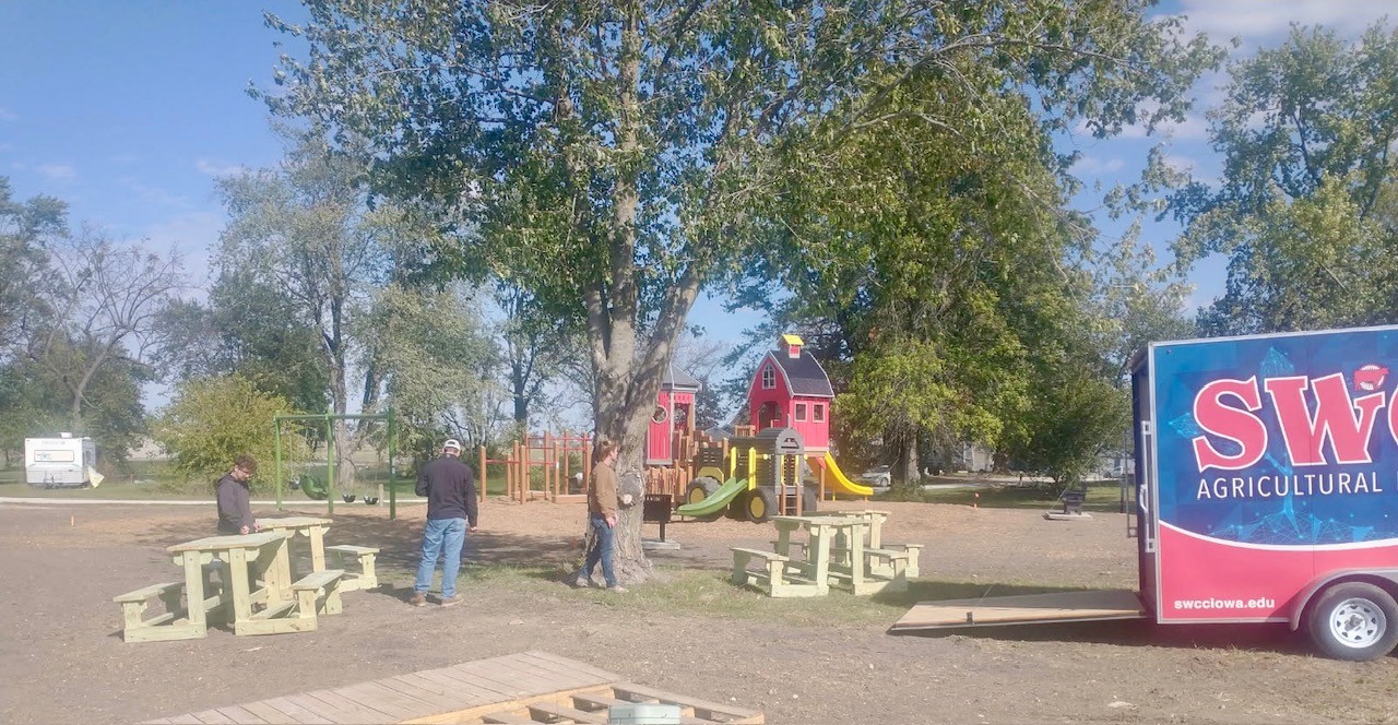 Carpentry students unloading benches at the Tingley City Park