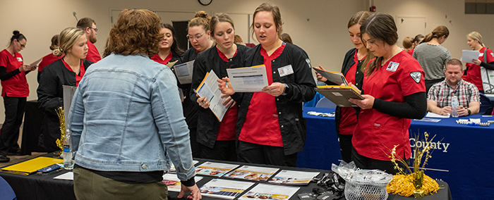 Students browsing tables at the career fair