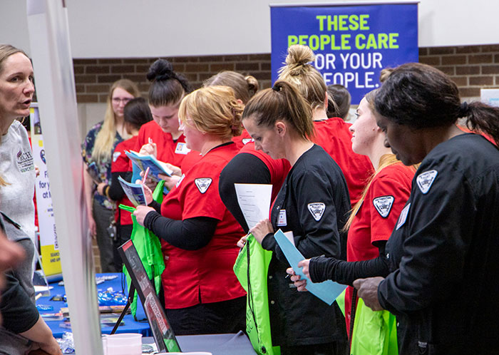Students browsing table at Health Careers Fair