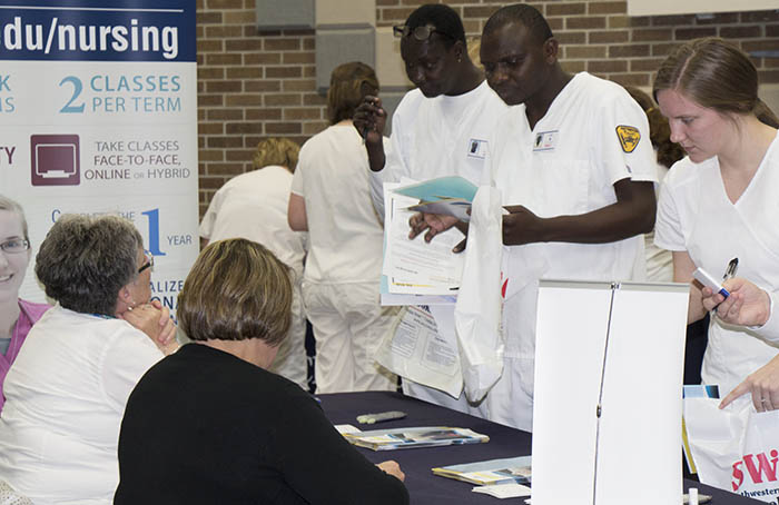 Students visiting with employer at table