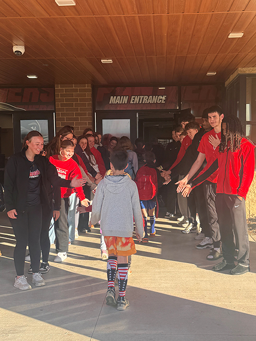 College students greeting elementary students at Creston Elementary