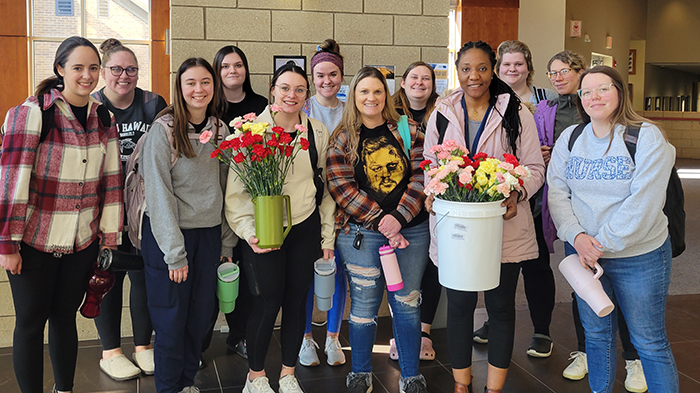 Nursing students with carnations ready to head to the nursing homes