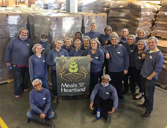 Students and instructors ready to package meals