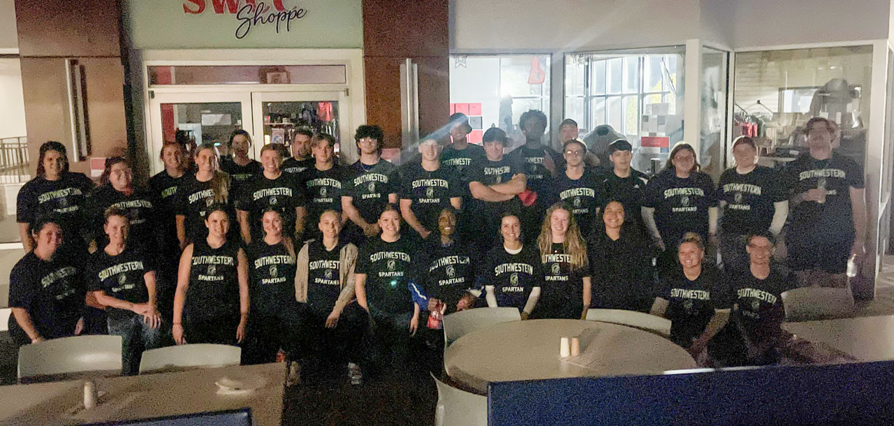The group of Tricky Treating participants from 2024 standing in the Student Center.