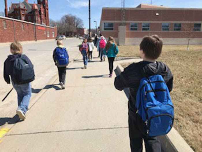 Walking School Bus Kids headed down the sidewalk to after-school program