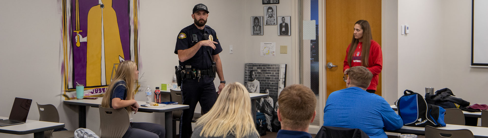 Police officer speaking to criminal justice class