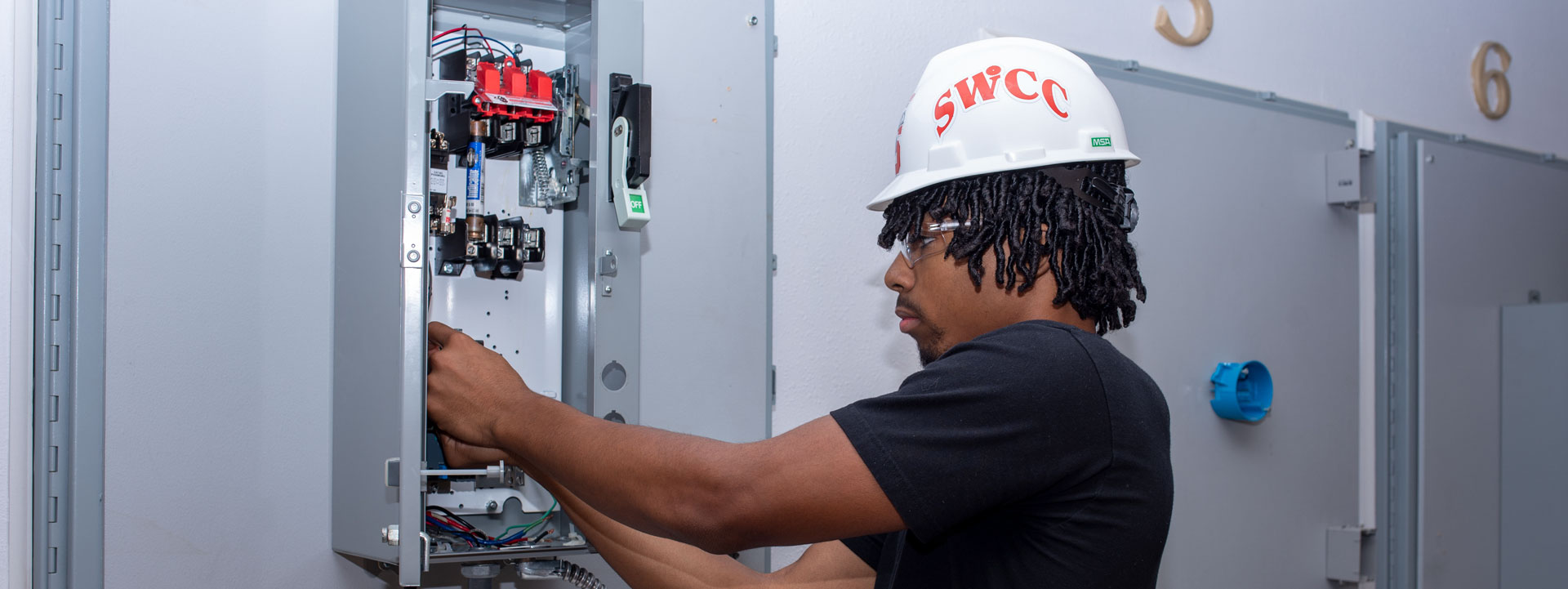 Student working in an electrical service box