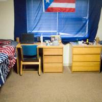 Sample shared room with two beds, a desk, and a dresser.