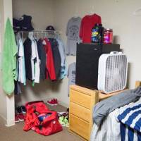 Sample shared room with two beds, a desk, and a dresser.