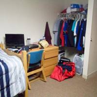 Sample shared room with two beds, a desk, and a dresser.