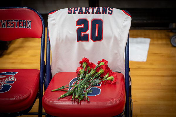 Red carnations on the bench seat left empty in Stewart’s honor