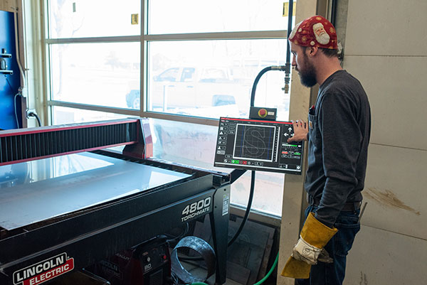 Welding instructor Luke Nelson operating the CNC plasma cutter