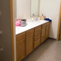 Shared bathroom area with sink and a large mirror for getting ready in the morning.