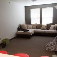 Living room area with couch and chairs
