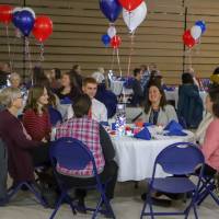 People sitting at a table at the donor scholar dinner