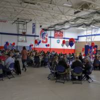 Tables of people in the gym at the Donor Scholar dinner