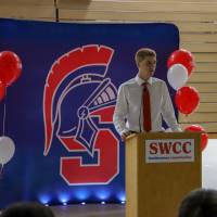 Student giving a speech during dinner